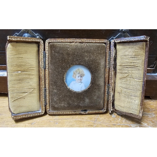 73 - A stunning antique miniature portrait of a child, in original carry case.