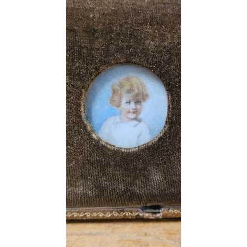 73 - A stunning antique miniature portrait of a child, in original carry case.