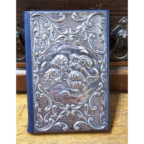 82 - A stunning Sterling Silver fronted notebook with decorative Cherub design, 12cm x 8cm.