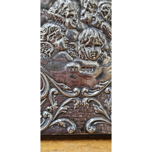 82 - A stunning Sterling Silver fronted notebook with decorative Cherub design, 12cm x 8cm.