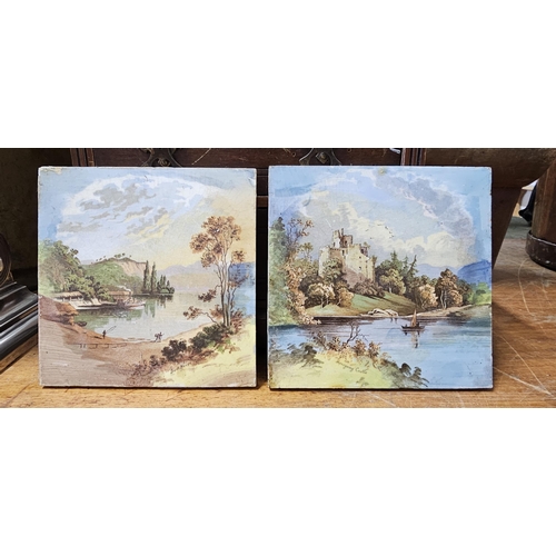 83 - A pair of decorative tiles showing decorative Country scenes.