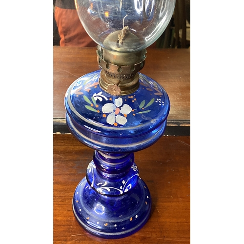 27 - A vintage hand painted blue glass oil lamp.