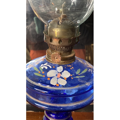 27 - A vintage hand painted blue glass oil lamp.