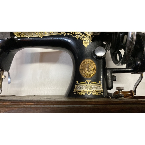 3 - A vintage cased Singer Sewing machine.