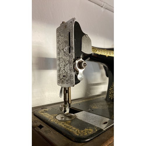 3 - A vintage cased Singer Sewing machine.