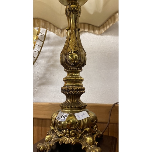 66 - A large heavy gilt metal table lamp and shade. 90cm in height.