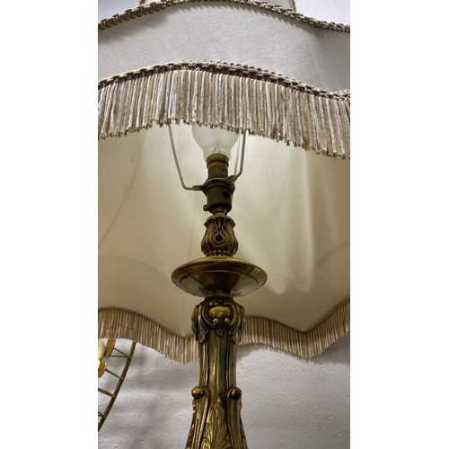 66 - A large heavy gilt metal table lamp and shade. 90cm in height.