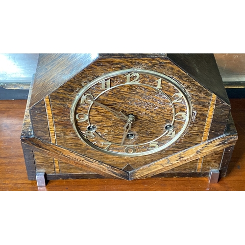 87 - A vintage oak mantle clock with brass dial.