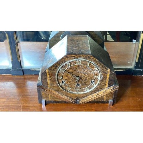 87 - A vintage oak mantle clock with brass dial.