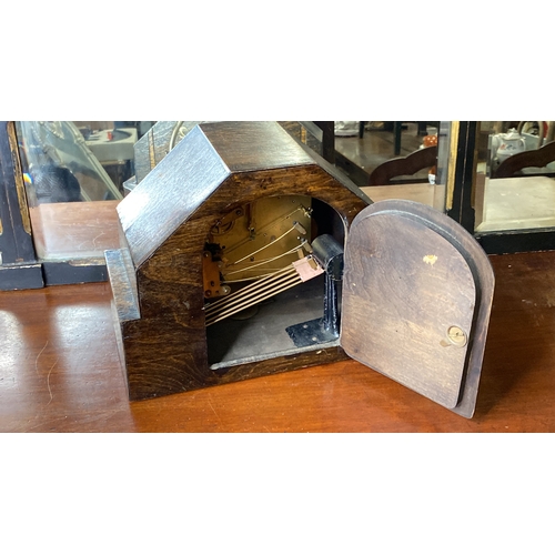 87 - A vintage oak mantle clock with brass dial.