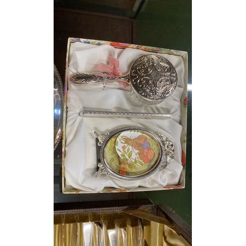 127 - A three piece boxed Christening set, plated sauceboats, assorted cutlery and more.