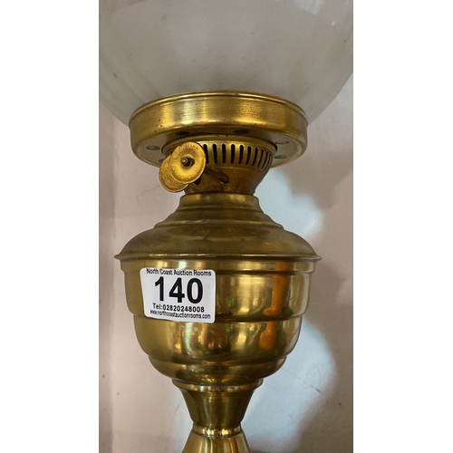 140 - A vintage brass based oil lamp with etched shade.