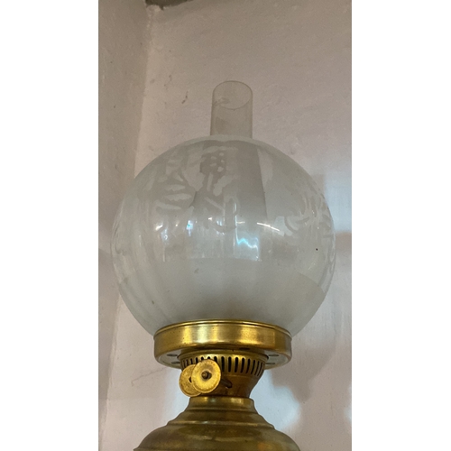 140 - A vintage brass based oil lamp with etched shade.