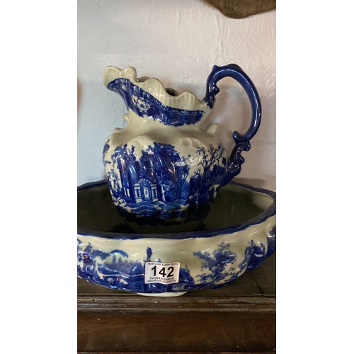 142 - A blue and white patterned jug and basin set.