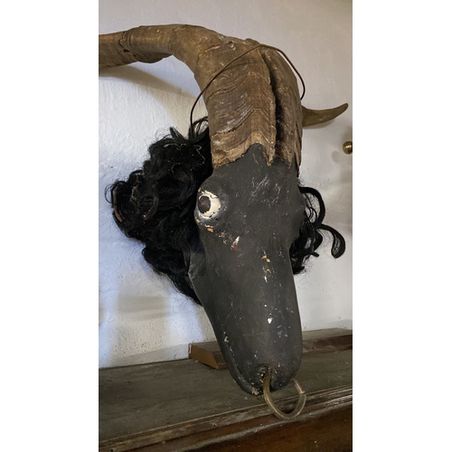 143 - A pair of antique taxidermy horns mounted on a plaster face.