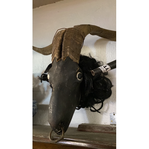 143 - A pair of antique taxidermy horns mounted on a plaster face.