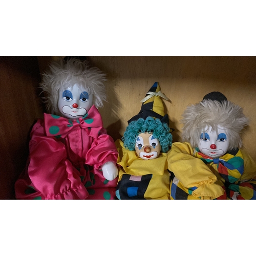 155 - Three porcelain faced clowns.