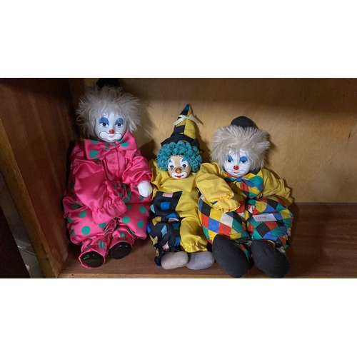 155 - Three porcelain faced clowns.