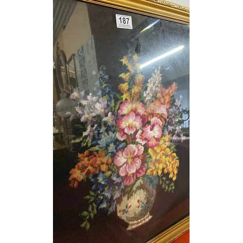 187 - A large tapestry panel of a vase and flowers,