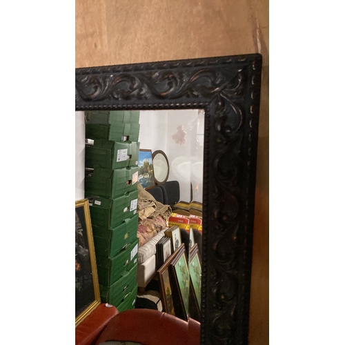 190 - A wall mirror with decorative frame.