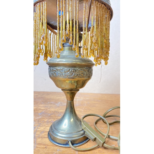 216 - A stunning antique table lamp with beaded glass shade.