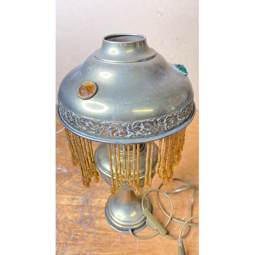 216 - A stunning antique table lamp with beaded glass shade.