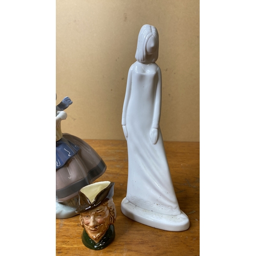 225 - A Lladro figure, a Hummel figure, a miniature Royal Doulton mask jug and more.