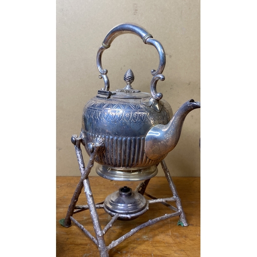 265 - A vintage silver plated spirit kettle and stand and two silver plated teapots.