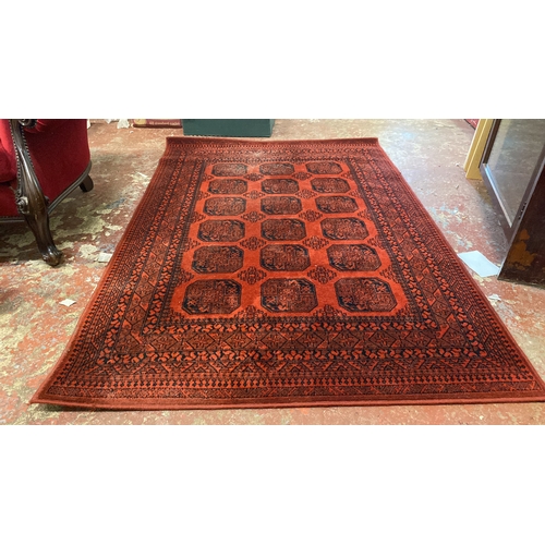 285 - An Afghan wool rug, measuring 134 x 190.