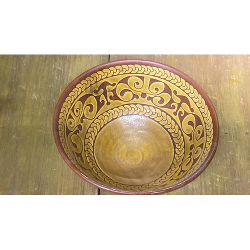 331 - A terracotta glazed bowl with decorative interior design, measuring 24cm.