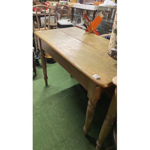 334 - A pine kitchen table, drop leaf at one side and an end drawer.