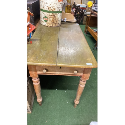 334 - A pine kitchen table, drop leaf at one side and an end drawer.