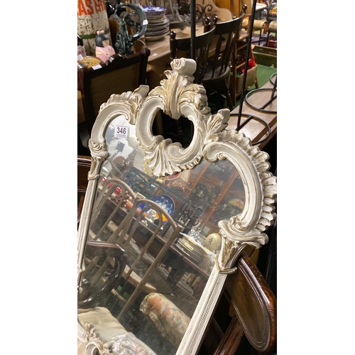 346 - An ornate resin framed wall mirror, measuring 77cm x 41cm.