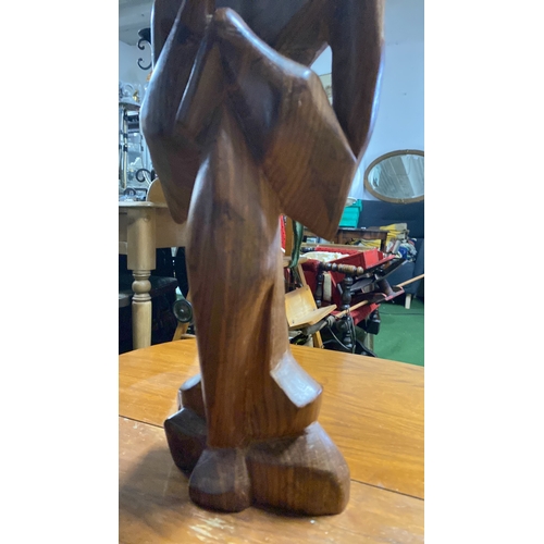 372 - An abstract carved wooden figure.