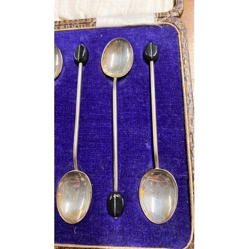 395 - A cased set of six Sterling Silver coffee bean teaspoons.