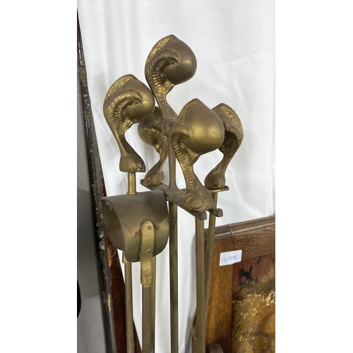 412 - A vintage brass lacquered companion set, ball and claw design,