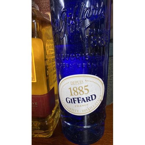 416 - A 70cl bottle of Jose Cuervo tequila and a 700ml 1885 Giffard Blue Curacao liqueur.