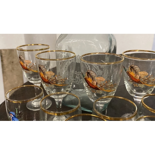 431 - A set of four and a set of six glasses with bird design and a glass decanter.