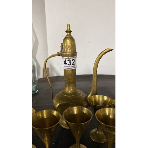 432 - A vintage Indian brass teapot and six cups.