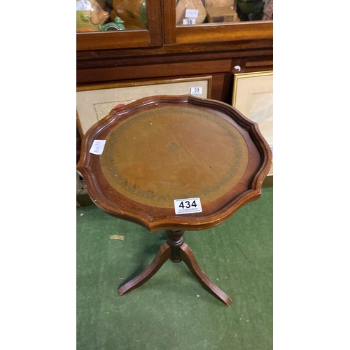 434 - A mahogany wine table with leather inset top.