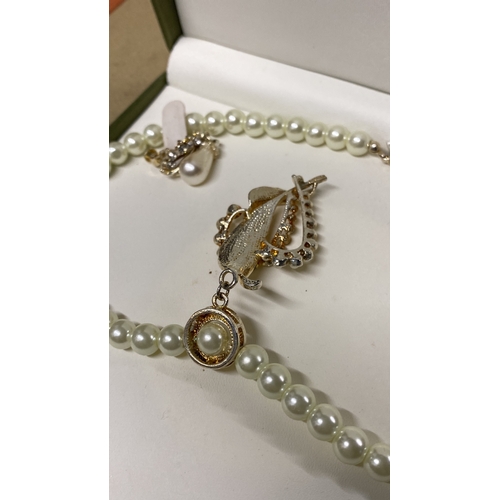 459 - A boxed Akoya pearl necklace and earring set.