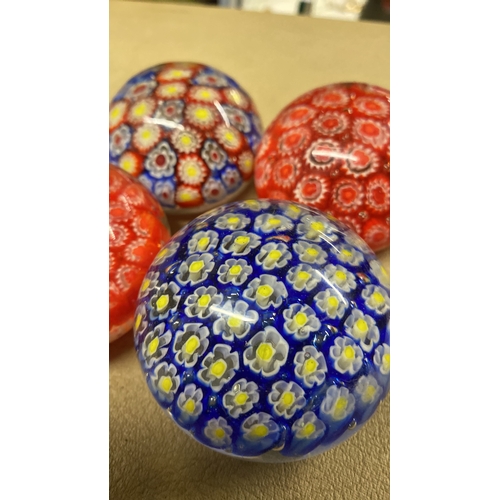 469 - Four vintage glass paperweights.