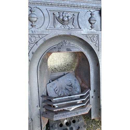 485 - An antique cast iron fireplace.