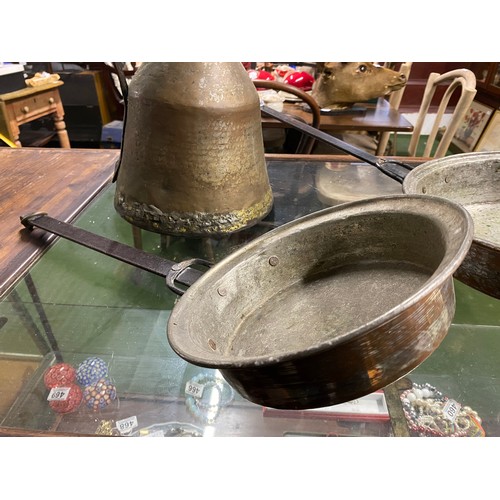 70 - Two antique pans and a metal pitcher.