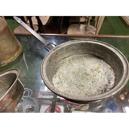 70 - Two antique pans and a metal pitcher.