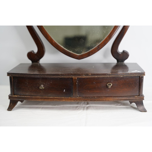 103 - A mahogany shield shaped dressing table mirror.