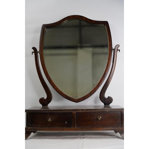 103 - A mahogany shield shaped dressing table mirror.