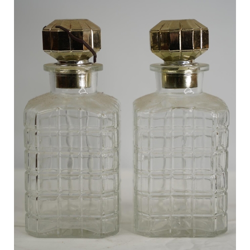 104 - A pair of glass decanters with gilt silver plated stoppers.