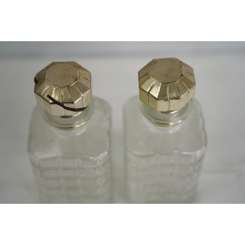 104 - A pair of glass decanters with gilt silver plated stoppers.