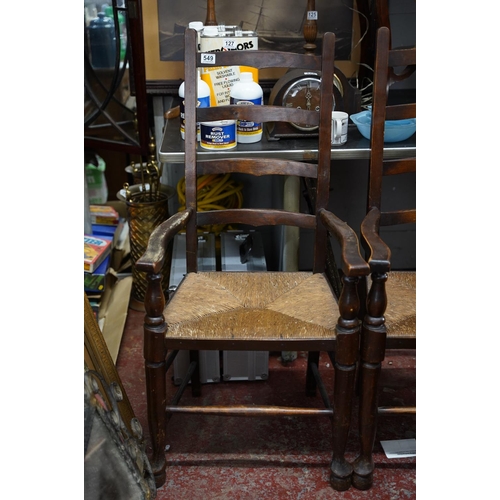 110 - A pair of oak framed ladder back armchairs